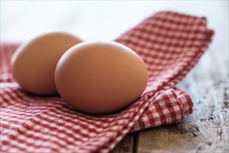 Eggs lying on tablecloth.