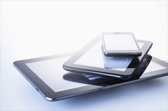 Smart phone lying on digital tablets.