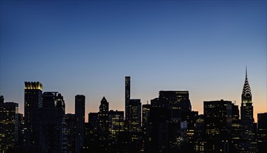 New York skyline at dusk with Chrysler Building. USA, New York, New York City.