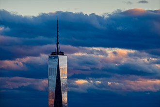 One World Trade Center against dramatic sky at dusk. USA, New York, New York City.