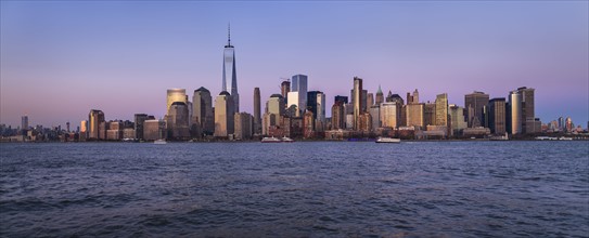 Urban skyline at dusk. USA, New York, New York City.