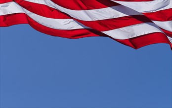 American flag against blue sky.