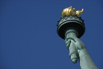 Torch of Statue of Liberty against clear sky. USA, New York, New York City.