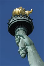 Torch of Statue of Liberty against clear sky. USA, New York, New York City.