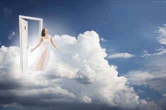 Young woman getting out from door in clouds.
