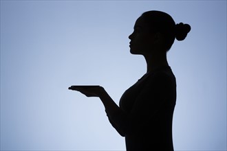 Silhouette of waitress on blue background