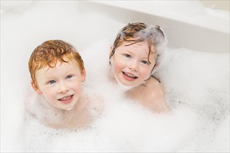 Sister and brother (2-3, 4-5) having bubble bath