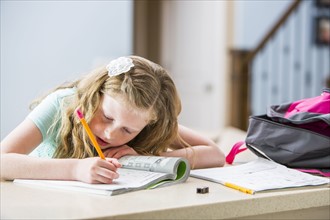 Girl (8-9) doing homework