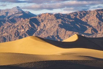 Mountain range with sand dunes in foreground