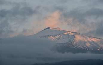Snowcapped mountain at sunset