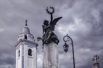 Statue and bell tower of Our Lady Del Pilar Church