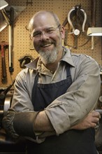 Portrait of smiling jeweler in workshop
