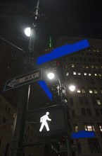 Low-angle view of directional signs in city