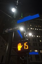 Low-angle view of directional signs in city