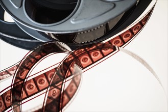 Close-up of film reel against white background.