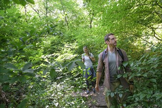 Couple walking in woodlands.