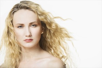 Portrait of beautiful woman with long, blond, curly hair.