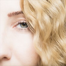 Green eye of beautiful blonde woman.