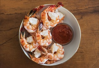 Shrimps and cocktail sauce in bowl