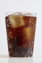 Studio shot of cold drink with ice cubes on white background