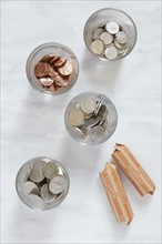 Overhead view of coins in glasses