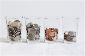 Row of glasses with coins