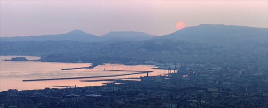 Italy, Campania, Naples, Panorama of city at sunrise