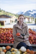 Austria, Salzburger Land, Maria Alm, Portrait of mature woman holding vegetables