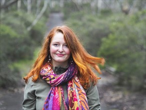 Portrait of smiling redhead woman in scarf