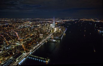 USA, New York, New York City, Aerial view of illuminated skyline at night.