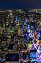 USA, New York, New York City, Manhattan, Aerial view of illuminated skyline with Times Square at night.