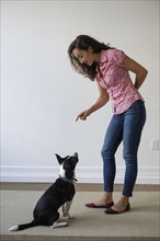 Young woman training her dog.