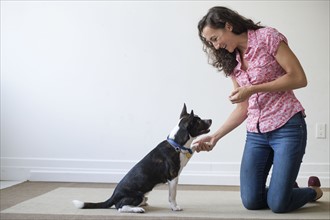 Young woman training her dog.