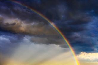 Multi colored dramatic sky with rainbow.
