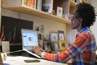 Woman using laptop in office.