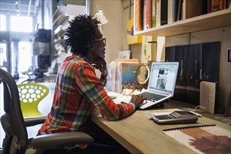 Woman using laptop in office.