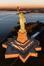 USA, New York State, New York City, Aerial view of Statue of Liberty at sunrise.