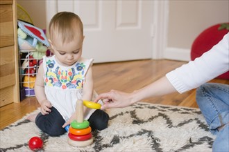 Baby girl (18-23 months) playing with mother