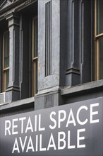 Close-up view of building facade with rental sign