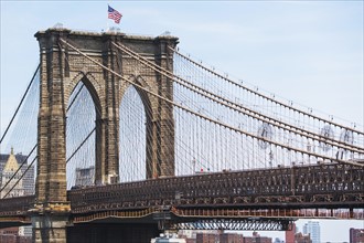 USA, New York State, New York City, Brooklyn Bridge with American flag on top