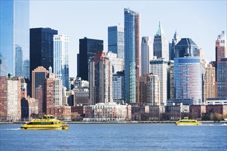 USA, New York State, New York City, Manhattan, City panorama with water taxis passing by