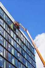 USA, New York State, New York City, Crane by glass facade