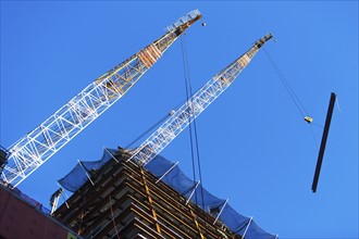 USA, New York State, New York City, Manhattan, Low angle view of cranes on construction site