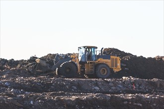 USA, New York State, New York City, Bulldozer on garbage dump