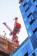 USA, New York, New York City, Office building with crane in background