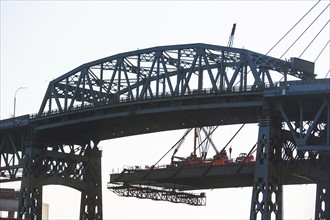 Silhouette bridge against sky