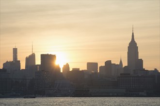 USA, New York, New York City, Sunrise over city