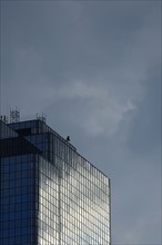 USA, Boston, Massachusetts, Glass office building and cloudy sky