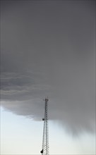 Storm clouds gathering above communications tower