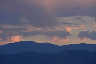 USA, Colorado, Denver, Colorful evening sky over mountain range